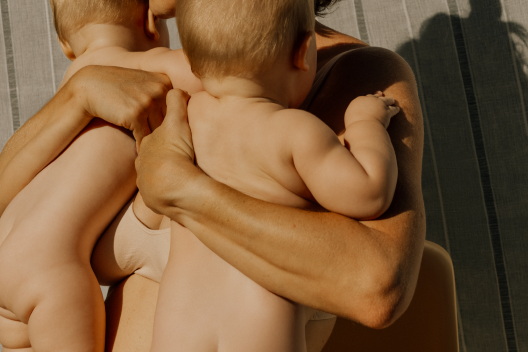 Woman holding two babies